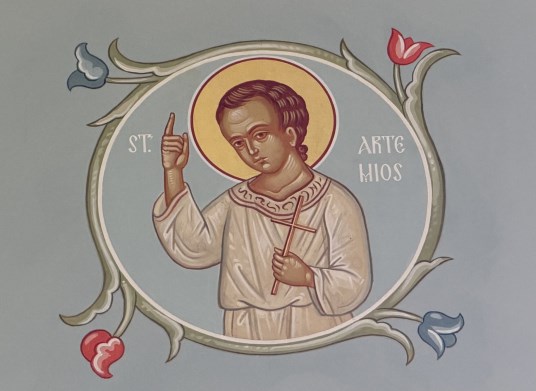 Icon of St. Artemius of Verkola, a young saint in a white robe raising his hand in blessing